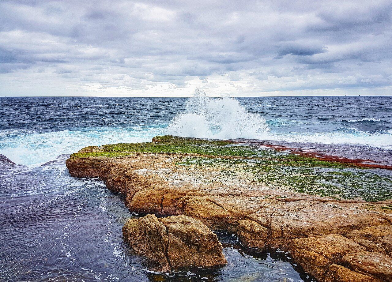 Waves crashing over Moes Rock at Jervis Bay Marine Park
