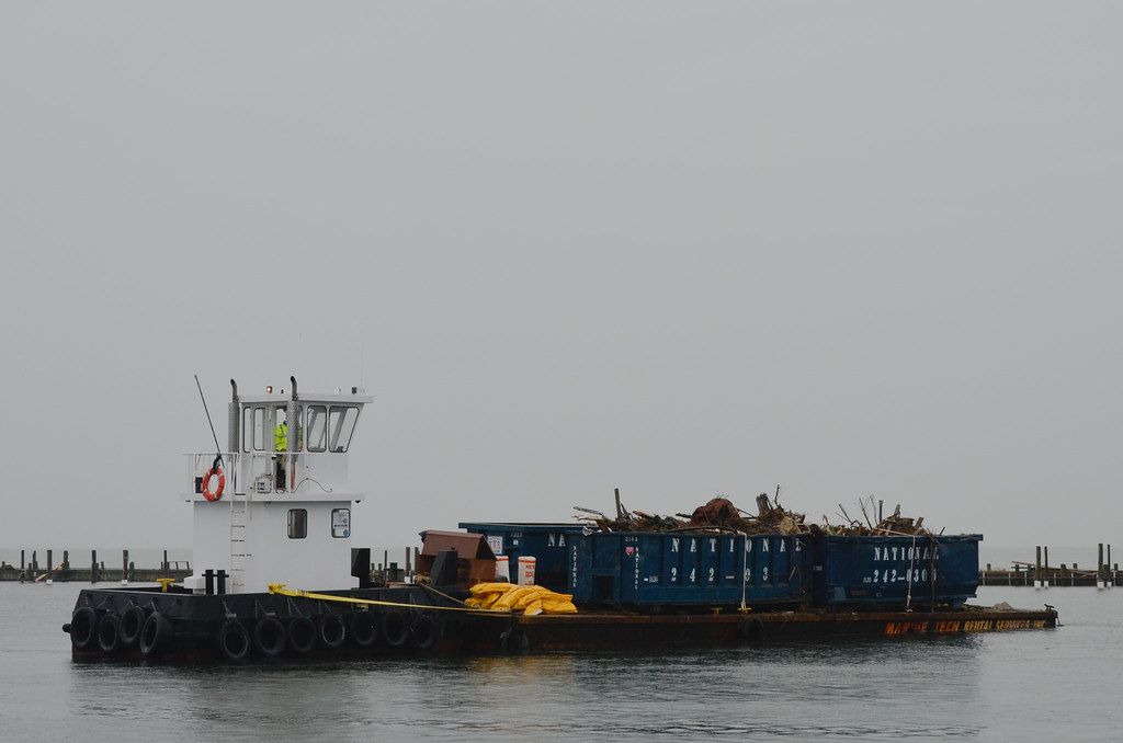 Loading first debris barges in Point of Woods