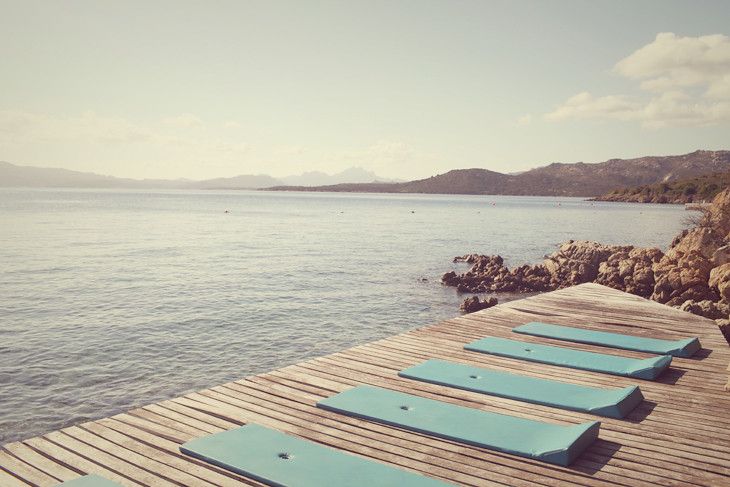Wooden deck with beach mattress over the sea