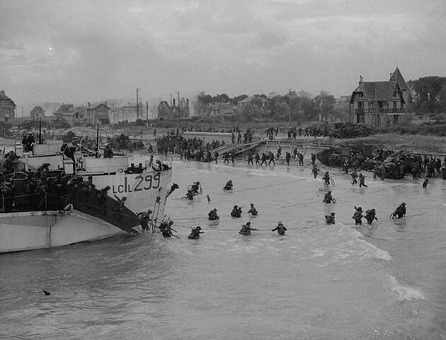 View looking east along 'Nan White' Beach, showing personnel of the 9th Canadian Infantry Brigade landing from LCI(L) 299 of the 2nd Canadian (262nd R