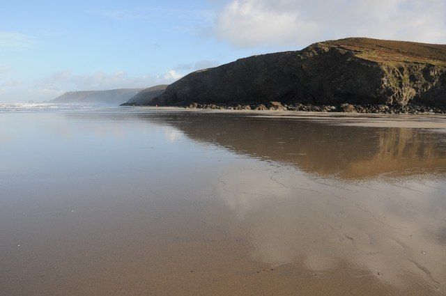 Clouds reflected in the wet sands