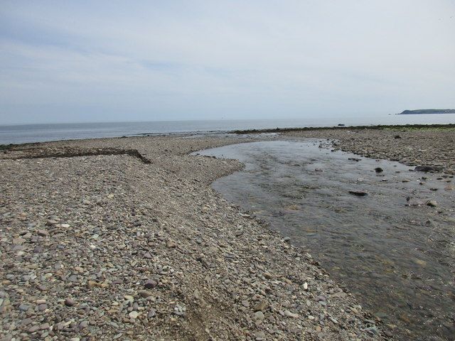 The Dalligan River crosses the beach near Ballyvoyle
