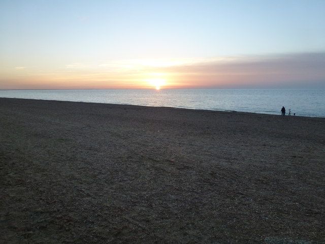 The sun sets over The Wash on Remembrance Sunday