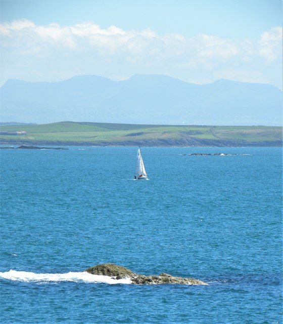 Sailing across Cymyran Bay