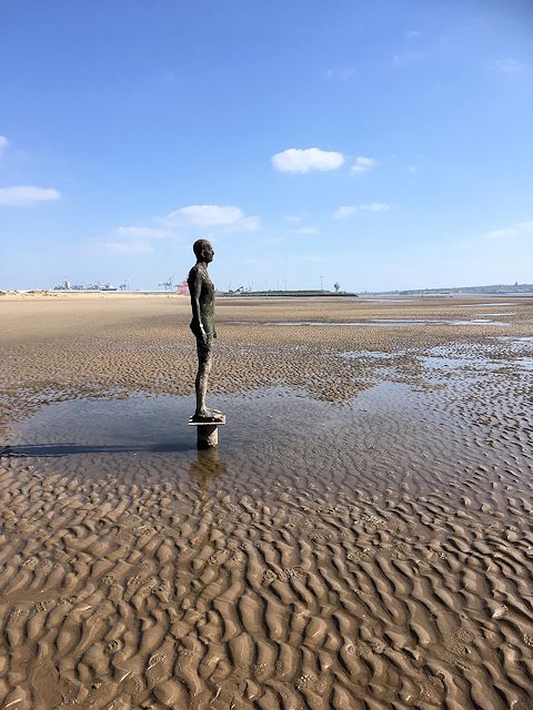 One of the iron men of Another Place on Crosby beach