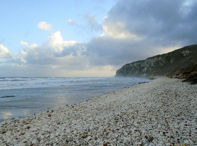 Chalk  stones  against  the  cliff  then  the  sand  beach